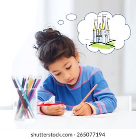 people  childhood  creativity   imagination concept    happy little girl drawing and crayons   dreaming about fairytale castle at home art school