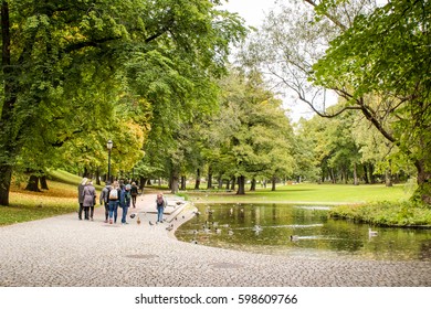 People Chilling Near A Lake In A Park In Oslo