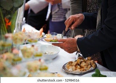 People choosing food from table on buffet party on wedding