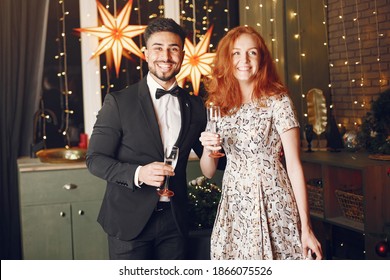 People in a Christman decorations. Man in a black suit. - Shutterstock ID 1866075526