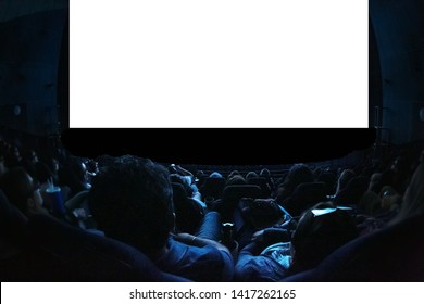 People In The Cinema Watching A Movie. Blank Empty White Screen. Leisure Entertainment Concept.