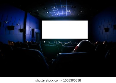 People In The Cinema Watching A Movie. Blank Empty White Screen