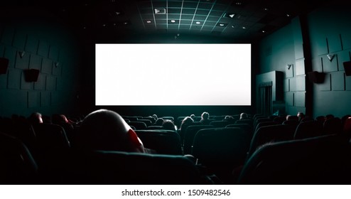 People In The Cinema Watching A Movie. Blank Empty White Screen