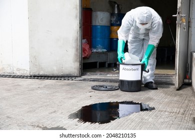 people cleaning chemical leak absorbent - Shutterstock ID 2048210135