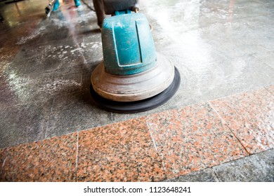 People Cleaning Floor With Machine.