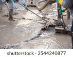 People cleaning and sweeping a muddy area after a severe flood in Valencia. Effects of the DANA