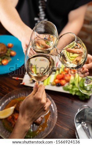 Two women enjoying a leisurely afternoon with wine outdoors