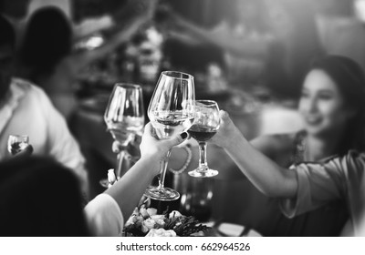 People clink glasses with wine after toast at the party