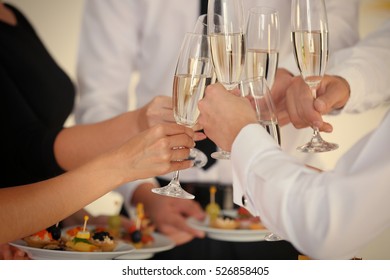 People Clinking Glasses At Buffet Catering Party, Close Up View