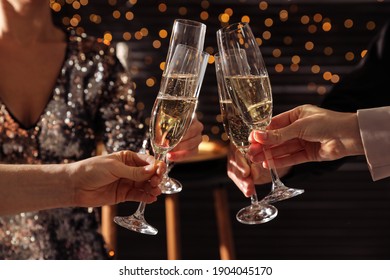 People clinking glasses of champagne indoors, closeup - Powered by Shutterstock