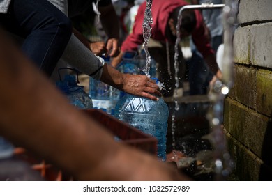 People Collecting Water In Plastic Bottles At Natural Water Spring During Drought At Newlands Cape Town South Africa.