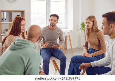 People communicating in group therapy. Adult men and women having psychotherapy session with professional therapist, sharing their issues and problems, talking about destructive feelings and emotions - Powered by Shutterstock