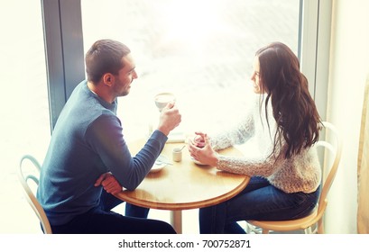 People, Communication And Dating Concept - Happy Couple Drinking Tea And Coffee At Cafe