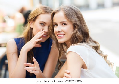 people communication and friendship concept - smiling young women drinking coffee or tea and gossiping at outdoor cafe - Shutterstock ID 419213206