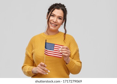 People Concept - Happy Smiling Young Woman With Pierced Nose With Flag Of United States Of America Over Grey Background