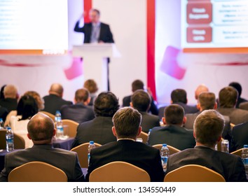 People At The Conference Hall. Rear View