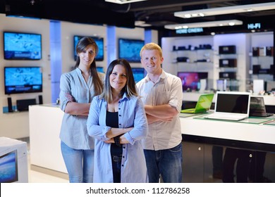 People In Consumer Electronics  Retail Store Looking At Latest Laptop, Television And Photo Camera To Buy