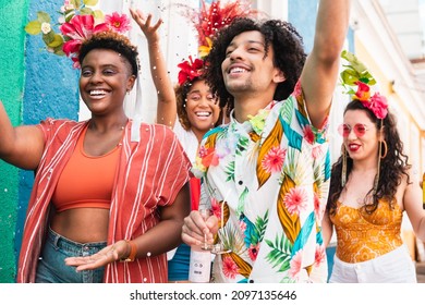 People in costume celebrates Carnival in Brazil. Group of friends have fun in brazilian holiday party. - Shutterstock ID 2097135646