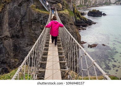 People Crossing The Carrick-a-rede Rope Bridge