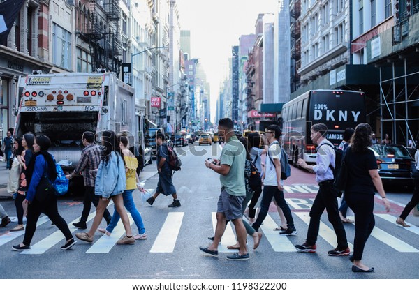 people are crossing crowded street in Time\
square \
New York city\
9/20/2018