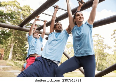 People crossing monkey bars on boot camp obstacle course - Powered by Shutterstock