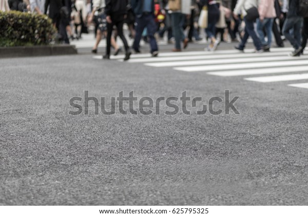 people crossing at a\
pedestrian crossing