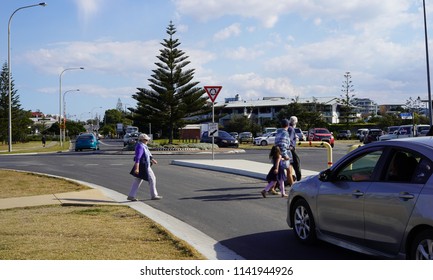 People Crossing Street In Australian City Of Coffs Harbour On 22 July 2018. Pedestrians Crossing Road While Cars Wait.                               