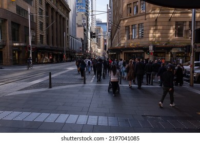 People Crossing Street In Sydney Australia On 30 August 2022. Busy Rush Hour Crowd At Traffic Intersection. Several People Crossing Green Traffic Lights In Central Business District In Australian City