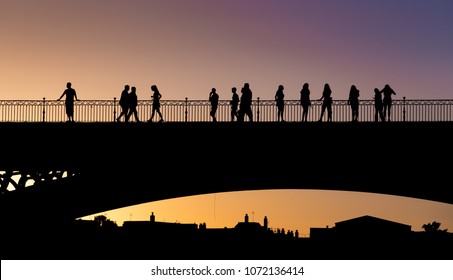 People Crossing The Triana Bridge Of Sevilla