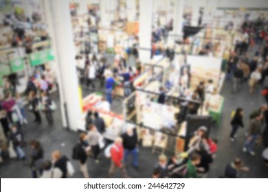 People Crowd, Panoramic View At Trade Show. Intentionally Blurred Post Production.