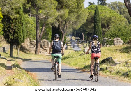people cycling along Appia Antica, Rome