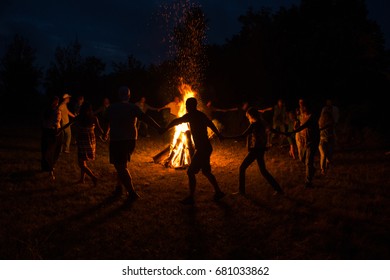 People Dance Around The Campfire. People Dance Around The Fire At Night.