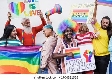 People Dancing At Gay Pride Parade With Rainbow Flag And Banner - Homosexual Love And Lgbt Concept