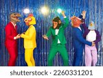 People in different animal disguises having fun at costume party. Group of happy people in bright suits and funny silly dinosaur, bird, ape, horse and dove masks dancing on blue foil fringe background