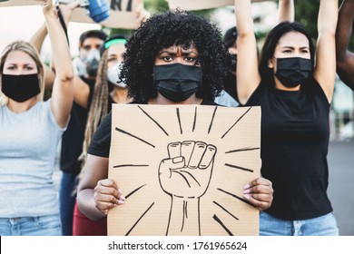 People from different culture and races protest on the street for equal rights - Demonstrators wearing face masks during black lives matter fight campaign - Focus on black girl eyes
