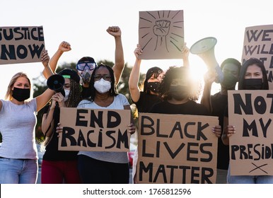 People from different culture and races protest on the street for equal rights - Demonstrators wearing face masks during black lives matter fight campaign - Focus on black girl eyes