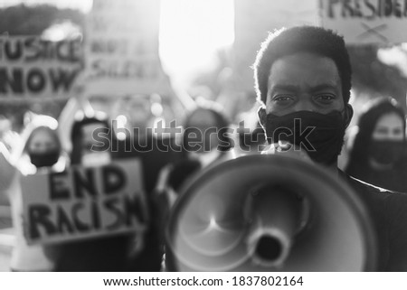 People from different culture and races protest on the street for equal rights - Focus on black man eyes