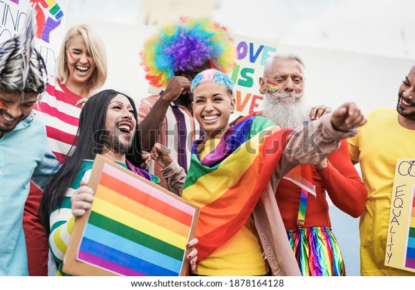 People from different\
generations have fun at gay pride parade with banner - Lgbt and\
homosexual love concept
