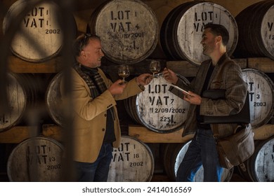 People in distillery tasing whiskey - Powered by Shutterstock