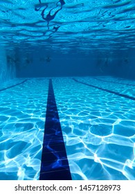 People Diving In A Swiming Pool. Underwater View.