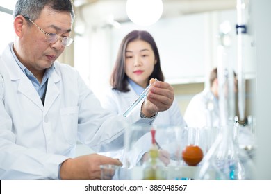 People Doing Chemical Experiment In Modern Lab