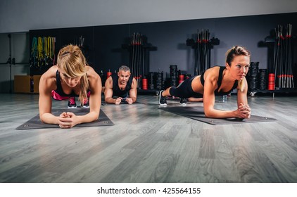 People Doing Push Ups In Fitness Class