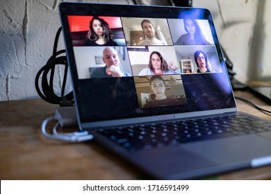 People Doing A Virtual Meeting Online.  Laptop On Work From Home Desk.  Coworkers In A Team Meeting During COVID-19 Coronavirus Pandemic.