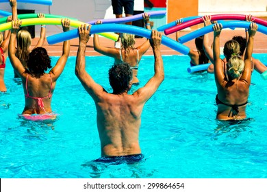 People Doing Water Aerobics In A Pool Of A Resort