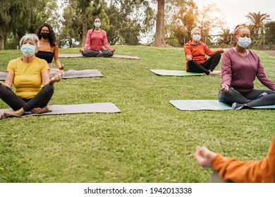 People Doing Yoga Class Outdoor Sitting On Grass While Wearing Safesty Masks During Coronavirus Outbreak - Social Distance And Sport Concept - Main Focus On Top Girl Face