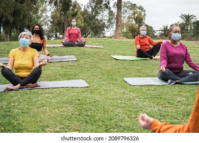 People Doing Yoga Class Outdoor While Wearing Safety Masks During Coronavirus Outbreak - Focus On Left Caucasian Senior Face