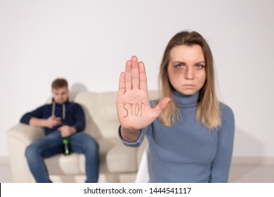 People, domestic violence and abuse concept - Woman shows stop abusing sign over man's background