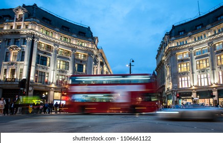 People And Double Decker Red Bus Cross Oxford Circus, The Busy Intersection Of Oxford Street And Regent Street In The West End Of London