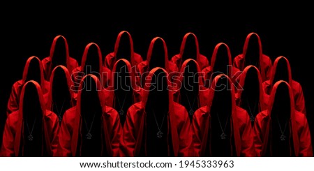 People dressed in a red robes looking like a cult members on a dark background. No face. Occult, sect concept. 