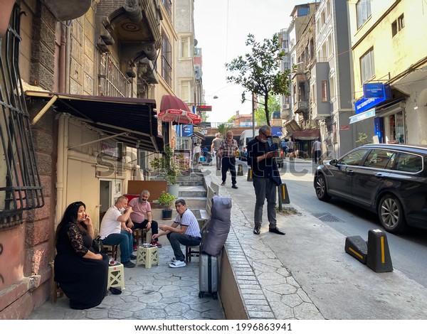 People drink tea at a street cafe in\
Beyoglu district in Istanbul, Turkey. May 24,\
2021.